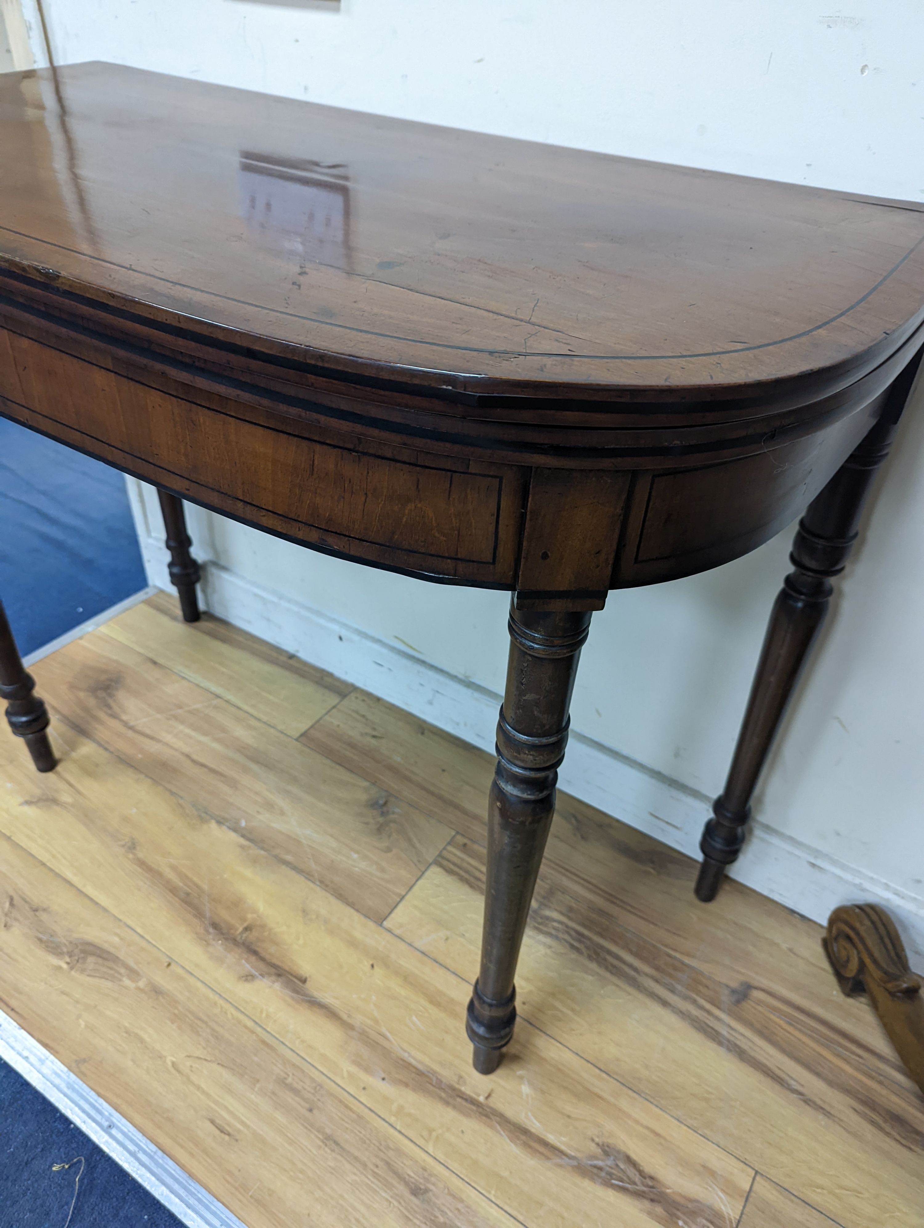 A Regency mahogany D shaped folding card table, width 91cm, depth 46cm, height 74cm